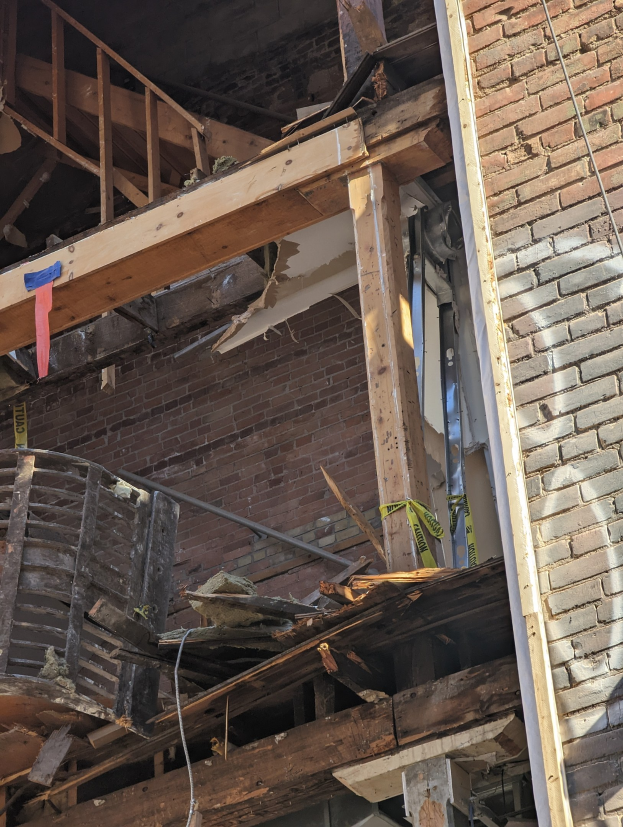 Teilweise abgerissenes Gebäude mit verstreuter Trümmer, zerbrochene Fenster und Türen nach der Abriss.