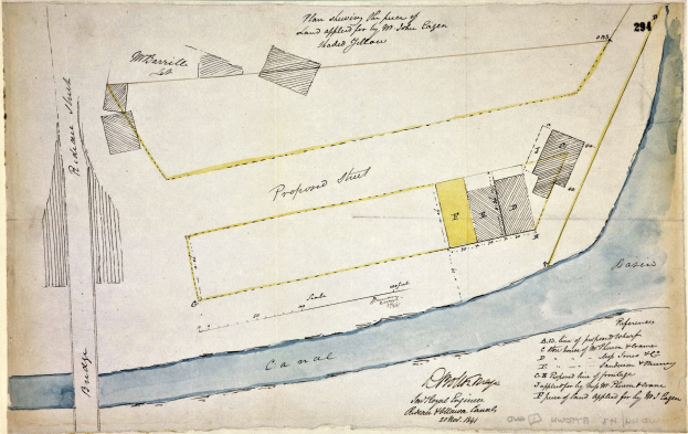 Eine detaillierte Karte auf Papier mit Straßen, Gebäuden und Sehenswürdigkeiten, begleitet von erklärendem Text über die Größe, Lage und Merkmale der Stätte.